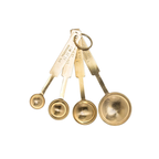 Set of four gold measuring spoons on a white background